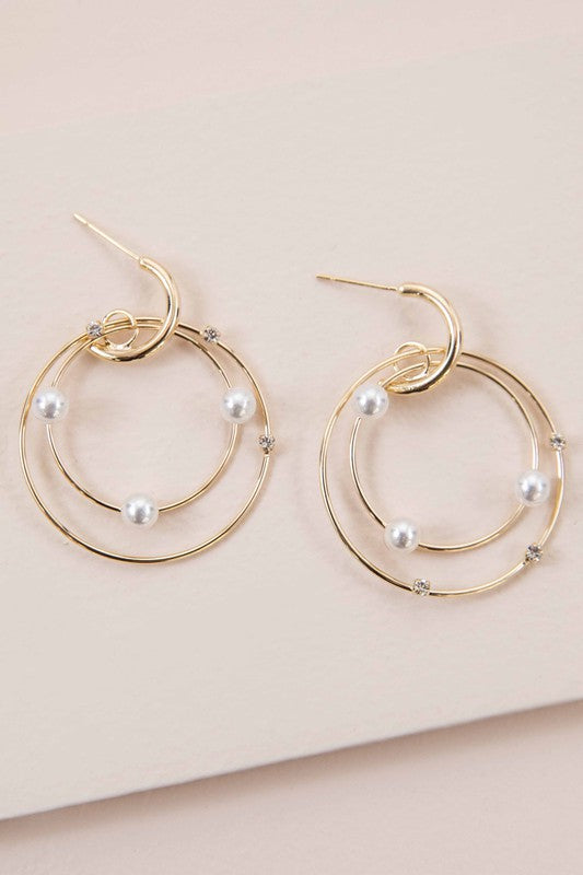 The Fawn Pearl Hoop Earrings, elegantly enhanced with pearls, gleam on a pristine white background, featuring lustrous 10k gold plating.