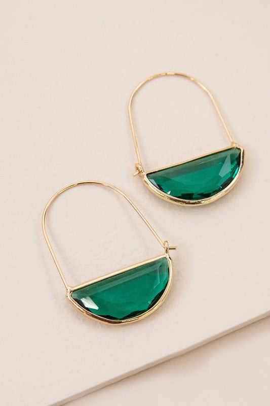 Glacier Hoop Earrings in 10k gold plating feature semi-circle emerald green stones, elegantly displayed on a light beige surface.