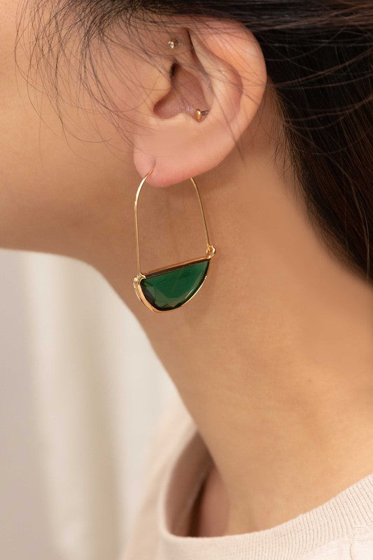 Glacier Hoop Earrings in 10k gold plating feature semi-circle emerald green stones, elegantly displayed on a light beige surface.