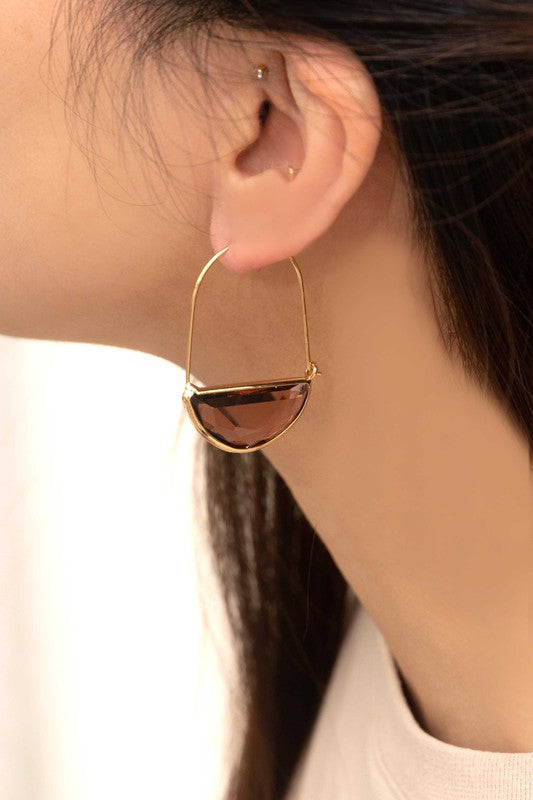 Glacier Hoop Earrings in 10k gold plating feature semi-circle emerald green stones, elegantly displayed on a light beige surface.