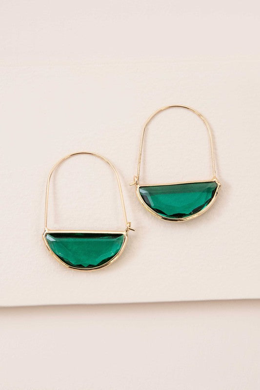 Glacier Hoop Earrings in 10k gold plating feature semi-circle emerald green stones, elegantly displayed on a light beige surface.