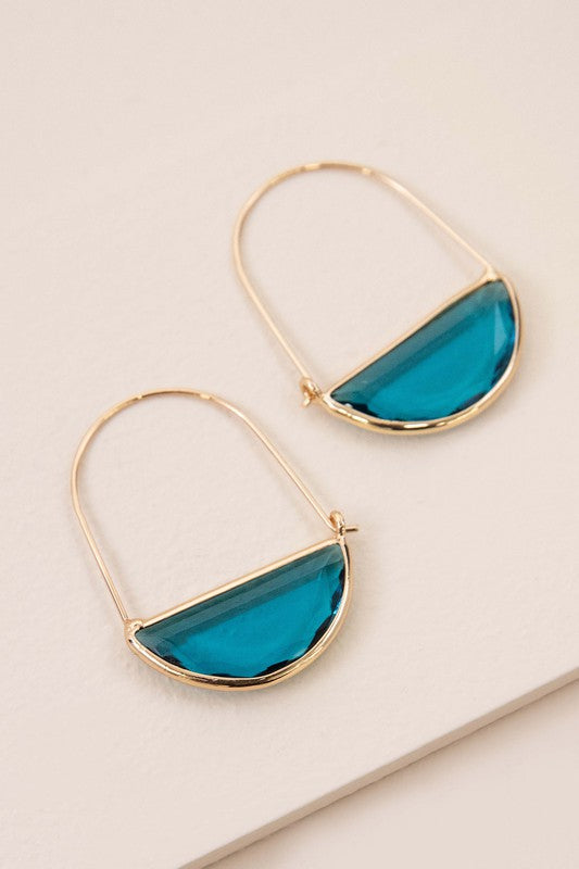 Glacier Hoop Earrings in 10k gold plating feature semi-circle emerald green stones, elegantly displayed on a light beige surface.