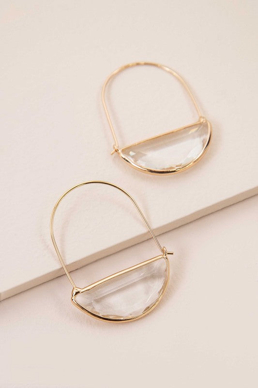 Glacier Hoop Earrings in 10k gold plating feature semi-circle emerald green stones, elegantly displayed on a light beige surface.