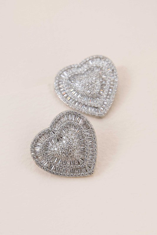 Pair of Amiya Heart Post Earrings on a pale background.