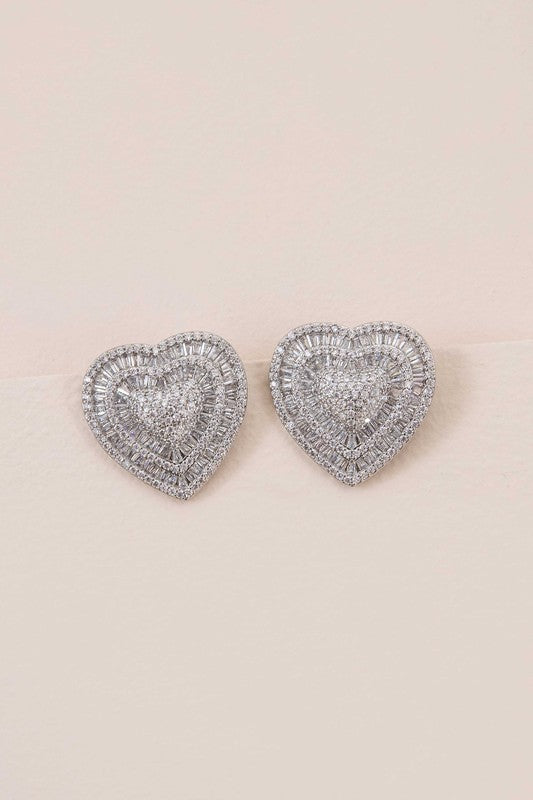 Pair of Amiya Heart Post Earrings on a pale background.