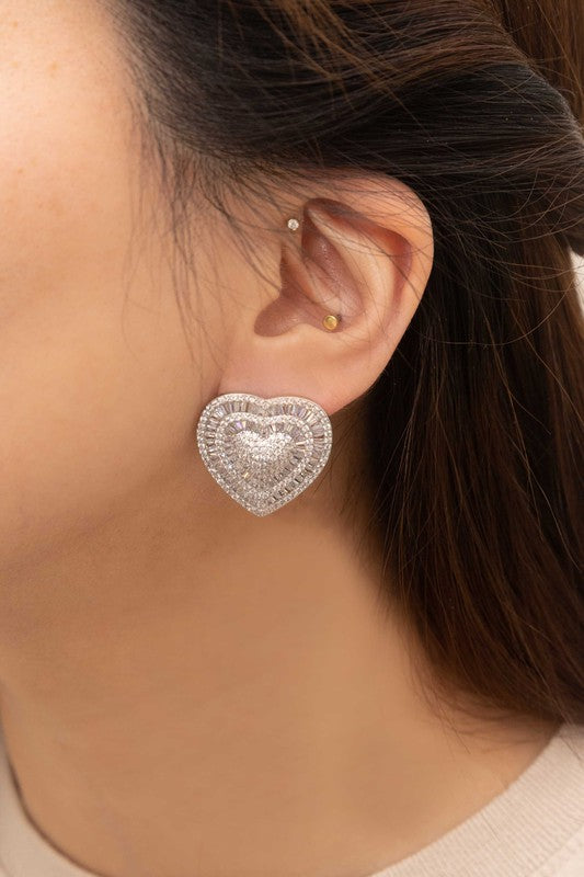 Pair of Amiya Heart Post Earrings on a pale background.