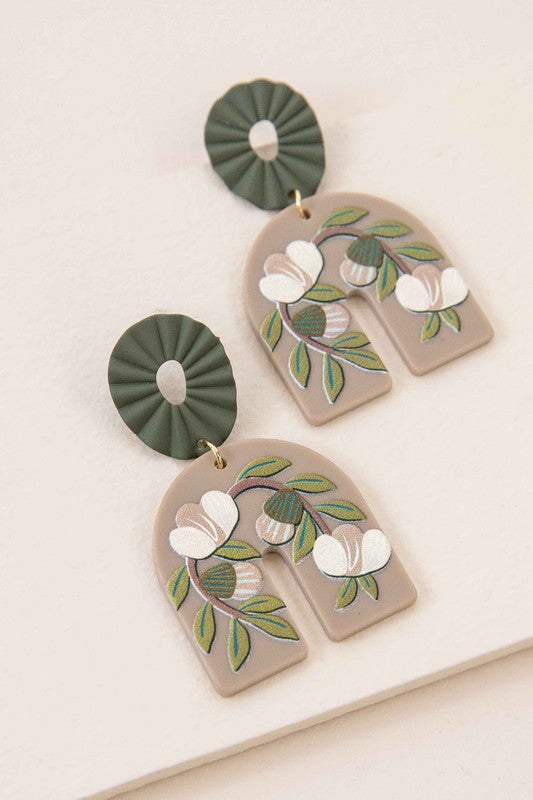 A pair of Terrace Drop Earrings with a floral vine image displayed against a light background.