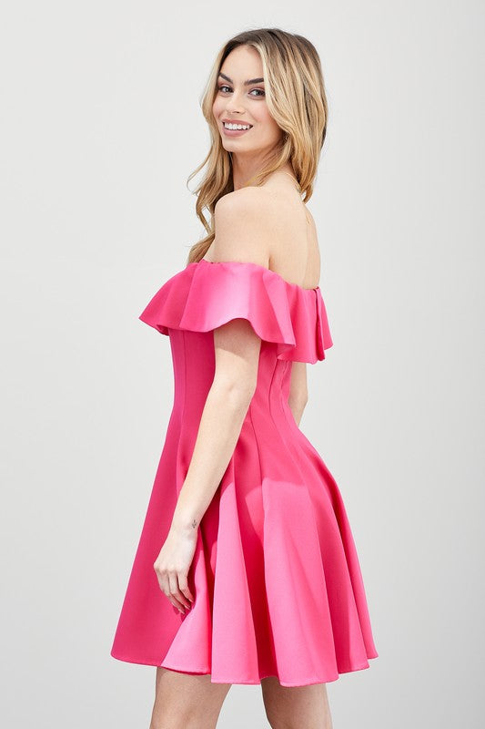 A woman in the quintessential A Line Ruffle Dress poses by a pool, the dress's flattering fit accentuated by the vibrant greenery in the background.