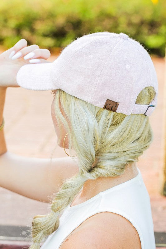 Woman wearing a CC Terry Cloth Baseball Hat backwards with a fishtail braid.