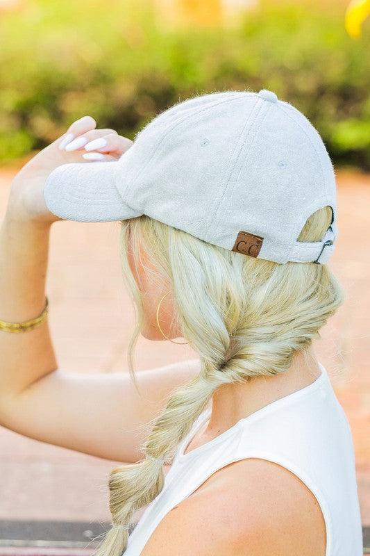 Woman wearing a CC Terry Cloth Baseball Hat backwards with a fishtail braid.