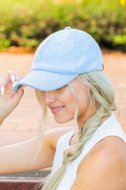 Woman wearing a CC Terry Cloth Baseball Hat backwards with a fishtail braid.