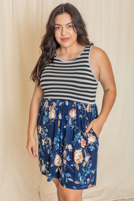 In the United States, a person poses in the Stripe Sleeveless Mini Dress, which features a black and gray striped top combined with a vibrant blue floral skirt.