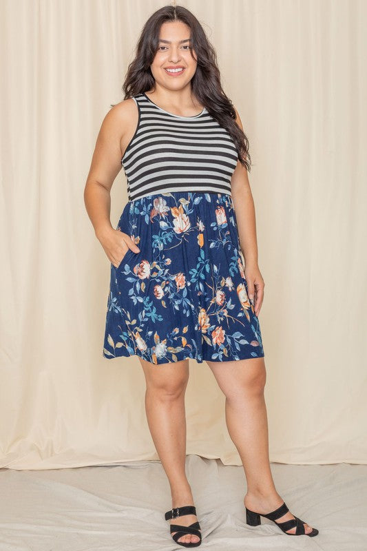 In the United States, a person poses in the Stripe Sleeveless Mini Dress, which features a black and gray striped top combined with a vibrant blue floral skirt.