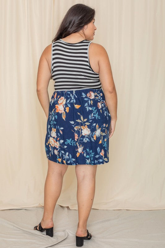 In the United States, a person poses in the Stripe Sleeveless Mini Dress, which features a black and gray striped top combined with a vibrant blue floral skirt.