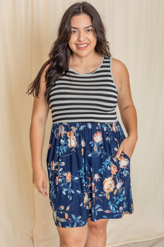 In the United States, a person poses in the Stripe Sleeveless Mini Dress, which features a black and gray striped top combined with a vibrant blue floral skirt.