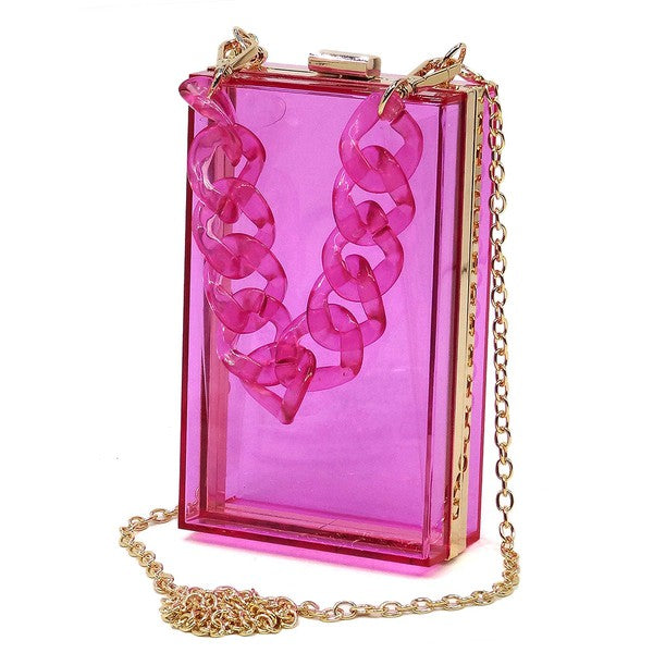 The Acrylic Chain Handle See Thru Crossbody Clutch is a rectangular pink acrylic crossbody clutch that features a sleek gold chain strap and a detachable shoulder chain, highlighted by an elegant pink acrylic chain handle.