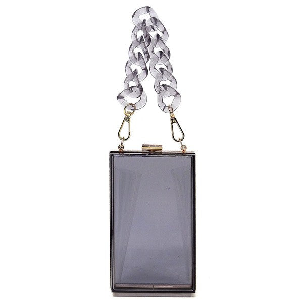 The Acrylic Chain Handle See Thru Crossbody Clutch is a rectangular pink acrylic crossbody clutch that features a sleek gold chain strap and a detachable shoulder chain, highlighted by an elegant pink acrylic chain handle.