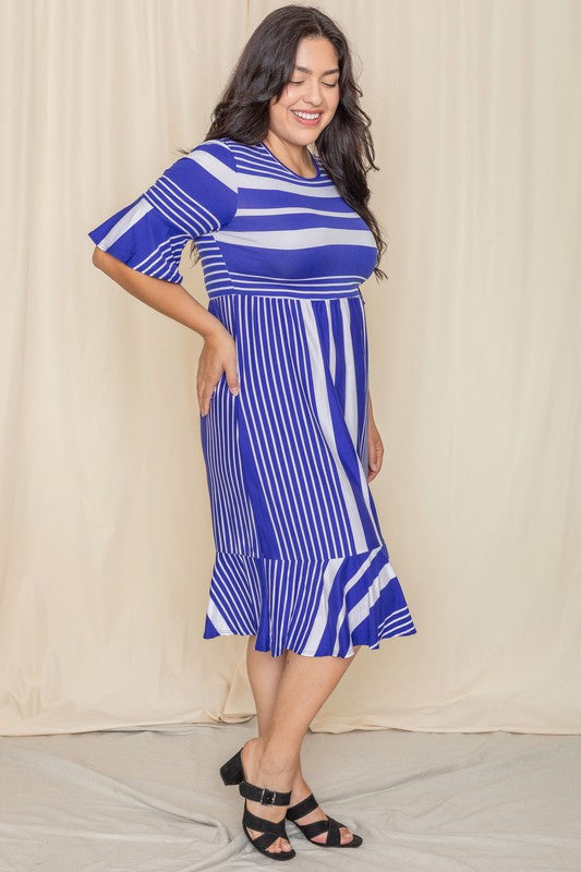 A person wearing a Plus Mix Stripe Ruffle Midi Dress stands against a beige background, smiling.