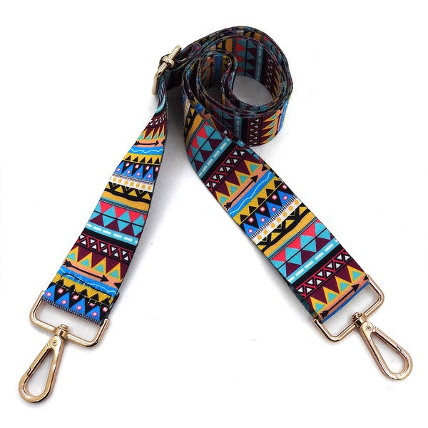 A coiled Fashion Rainbow Print Shoulder Strap that features vibrant colors and adjustable length, complete with gold clips on each end.