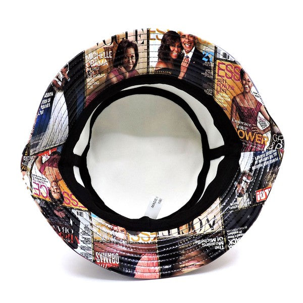 Introducing the Magazine Cover Collage Hat, a chic bucket hat available in one size. It showcases vibrant magazine covers depicting a woman in various poses and outfits, and is adorned with faux vegan leather accents for a perfect fusion of bold style and eco-friendly sophistication.