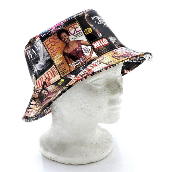 Introducing the Magazine Cover Collage Hat, a chic bucket hat available in one size. It showcases vibrant magazine covers depicting a woman in various poses and outfits, and is adorned with faux vegan leather accents for a perfect fusion of bold style and eco-friendly sophistication.