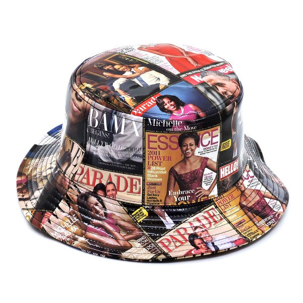 Introducing the Magazine Cover Collage Hat, a chic bucket hat available in one size. It showcases vibrant magazine covers depicting a woman in various poses and outfits, and is adorned with faux vegan leather accents for a perfect fusion of bold style and eco-friendly sophistication.