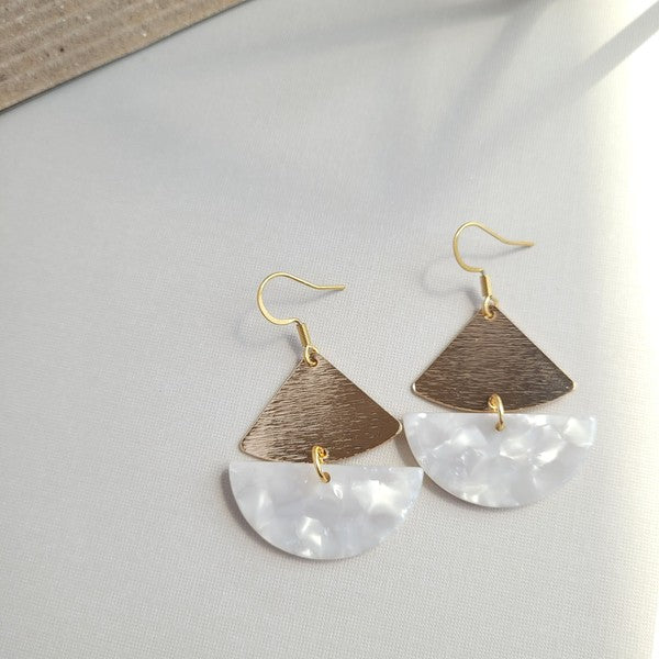 The Ava Pearl Earrings, crafted with 18K gold-plated details, gleam brilliantly on a hexagonal marble backdrop.