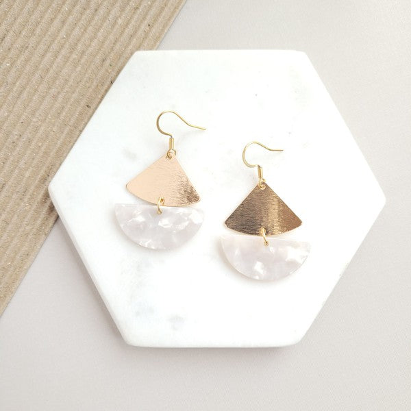 The Ava Pearl Earrings, crafted with 18K gold-plated details, gleam brilliantly on a hexagonal marble backdrop.