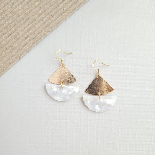 The Ava Pearl Earrings, crafted with 18K gold-plated details, gleam brilliantly on a hexagonal marble backdrop.