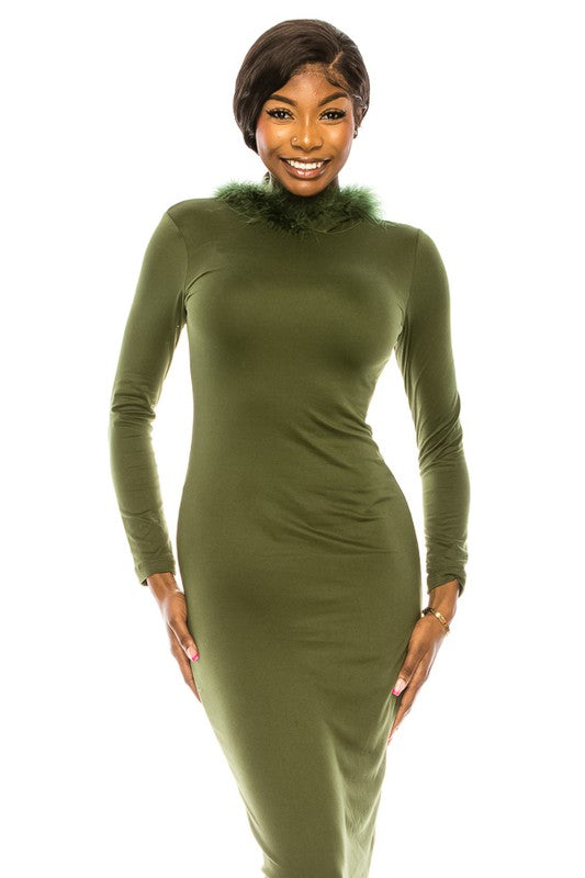 A woman in a black women's long dress with a hoodie and fur trim at the neckline is standing and smiling. She is wearing open-toe heels.