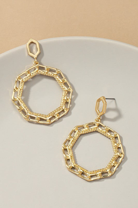 The Octagon chunky link chain hoop drop earrings, gold-plated with a geometric design, are elegantly displayed on a white surface.