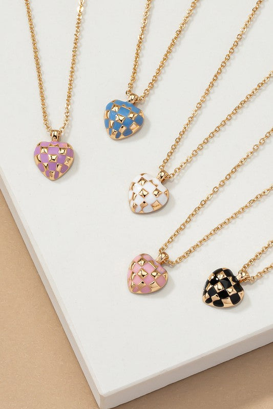 Introducing the Checker Heart Pendant Necklace: A collection of five necklaces showcasing a chic style with heart-shaped pendants. Each pendant features elegant enamel designs in pink, blue, white, and black on a beige background, adding a touch of sophistication to your ensemble.