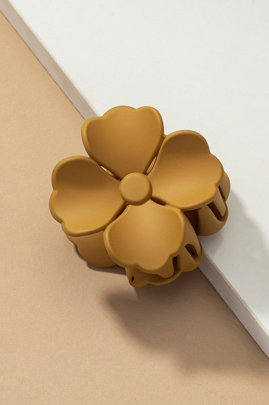 An elegant display of Matte Color Coated Flower Hair Claw Clips in soft Morandi shades is beautifully organized on a beige surface, creating a peaceful and fashionable look.