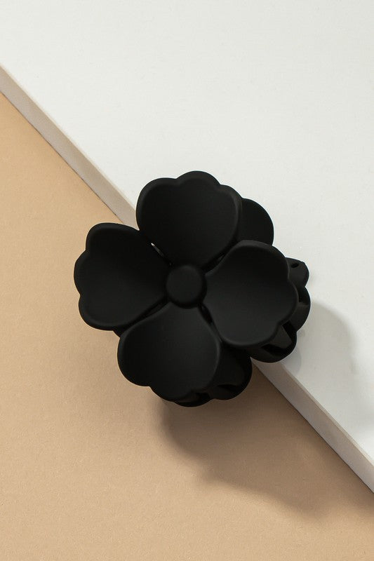 An elegant display of Matte Color Coated Flower Hair Claw Clips in soft Morandi shades is beautifully organized on a beige surface, creating a peaceful and fashionable look.