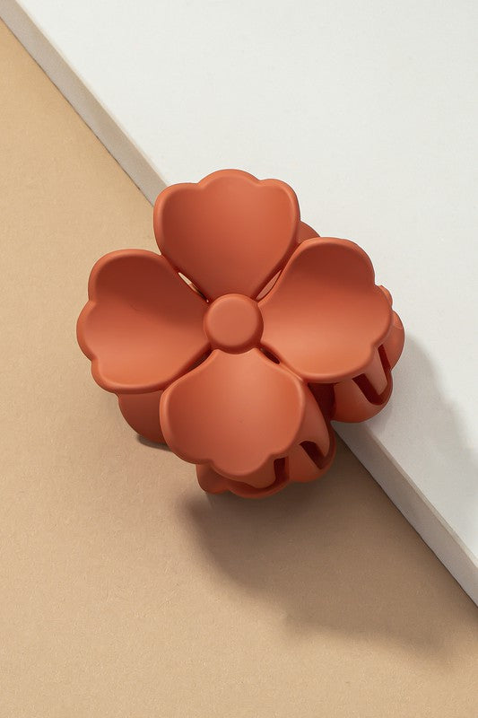 An elegant display of Matte Color Coated Flower Hair Claw Clips in soft Morandi shades is beautifully organized on a beige surface, creating a peaceful and fashionable look.