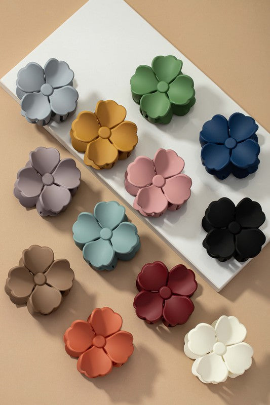 An elegant display of Matte Color Coated Flower Hair Claw Clips in soft Morandi shades is beautifully organized on a beige surface, creating a peaceful and fashionable look.