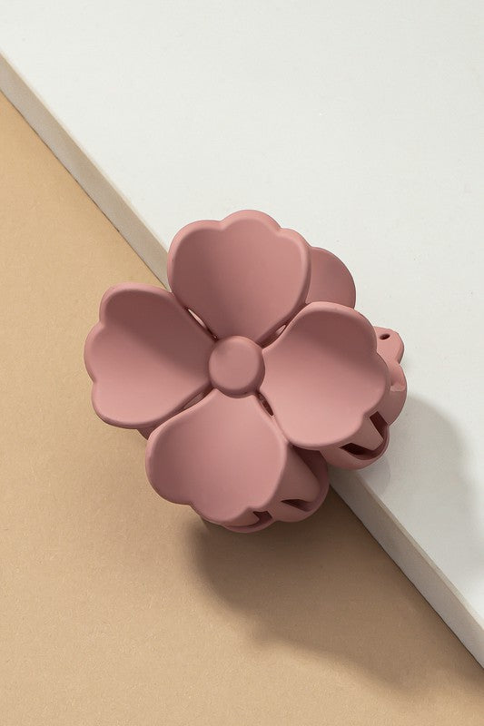 An elegant display of Matte Color Coated Flower Hair Claw Clips in soft Morandi shades is beautifully organized on a beige surface, creating a peaceful and fashionable look.