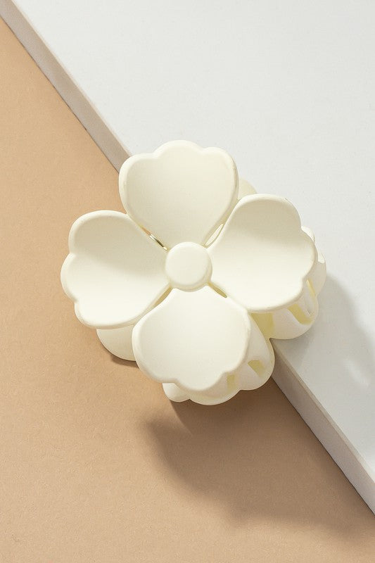 An elegant display of Matte Color Coated Flower Hair Claw Clips in soft Morandi shades is beautifully organized on a beige surface, creating a peaceful and fashionable look.