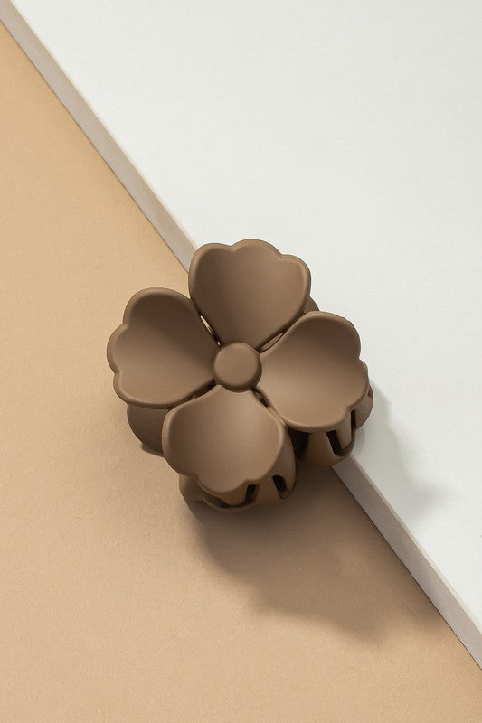 An elegant display of Matte Color Coated Flower Hair Claw Clips in soft Morandi shades is beautifully organized on a beige surface, creating a peaceful and fashionable look.