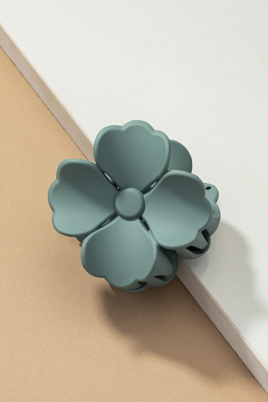 An elegant display of Matte Color Coated Flower Hair Claw Clips in soft Morandi shades is beautifully organized on a beige surface, creating a peaceful and fashionable look.