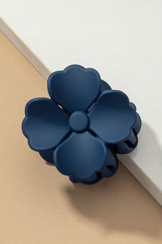 An elegant display of Matte Color Coated Flower Hair Claw Clips in soft Morandi shades is beautifully organized on a beige surface, creating a peaceful and fashionable look.