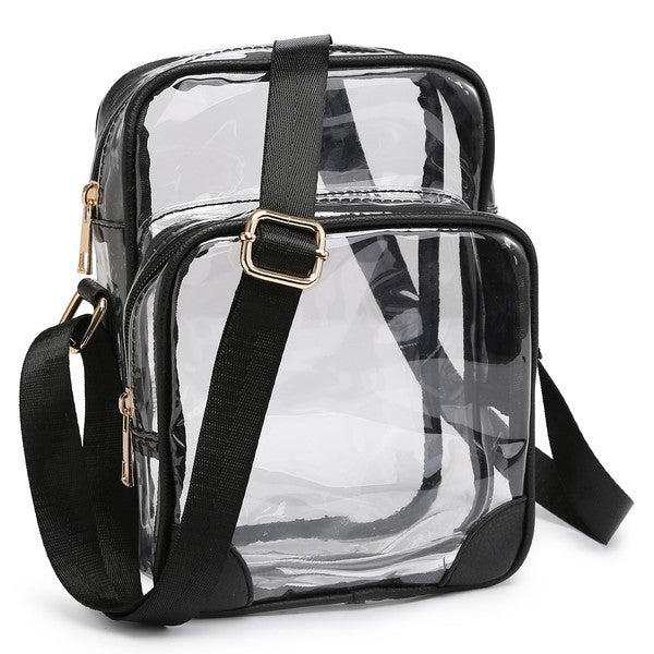 The See Thru Multi Compartment Crossbody Bag is a small, clear rectangular crossbody bag with blue trim and an adjustable blue shoulder strap. Made from faux leather, it features gold zipper closures on two compartments.