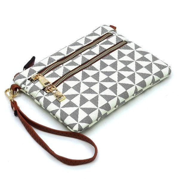 The Monogram Multi Zip Clutch Crossbody Bag Wristlet is a compact clutch with a geometric black and white triangle pattern, featuring a brown vegan leather wrist strap and gold zippers.