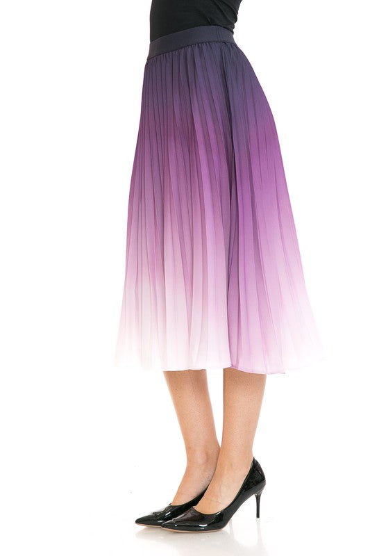 A woman with long blonde hair wears a black sleeveless top paired with the Women's High Waist Pleated A-Line Swing skirt featuring a purple to white gradient pleat and black ballet flats. She poses with one arm slightly bent and the other at her side.