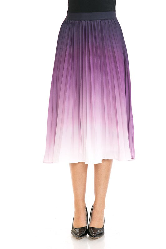 A woman with long blonde hair wears a black sleeveless top paired with the Women's High Waist Pleated A-Line Swing skirt featuring a purple to white gradient pleat and black ballet flats. She poses with one arm slightly bent and the other at her side.