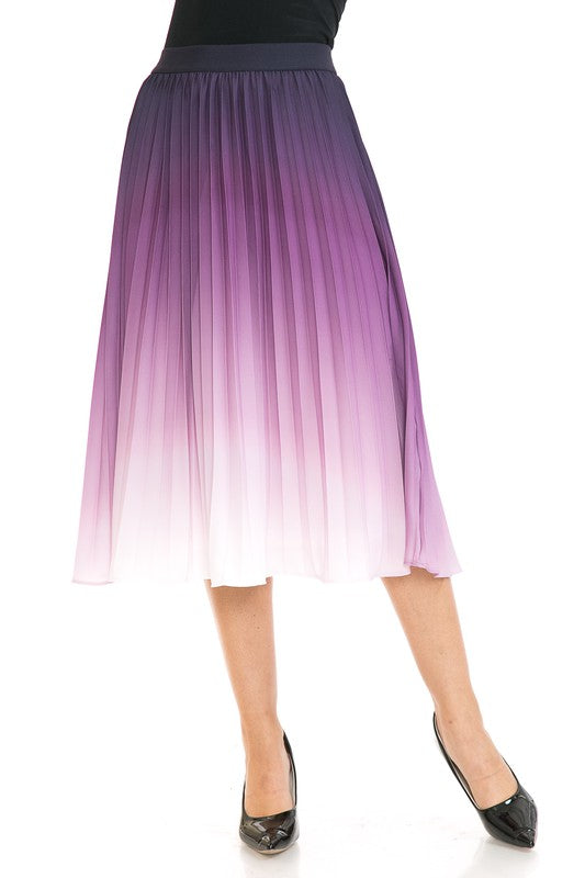 A woman with long blonde hair wears a black sleeveless top paired with the Women's High Waist Pleated A-Line Swing skirt featuring a purple to white gradient pleat and black ballet flats. She poses with one arm slightly bent and the other at her side.