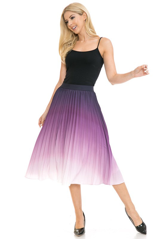 A woman with long blonde hair wears a black sleeveless top paired with the Women's High Waist Pleated A-Line Swing skirt featuring a purple to white gradient pleat and black ballet flats. She poses with one arm slightly bent and the other at her side.