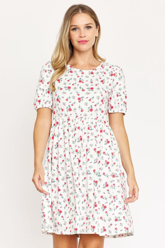 Woman wearing a Gathered Puff Sleeve Mini Dress in blue floral, made with a Polyester Spandex blend, standing against a plain white background.