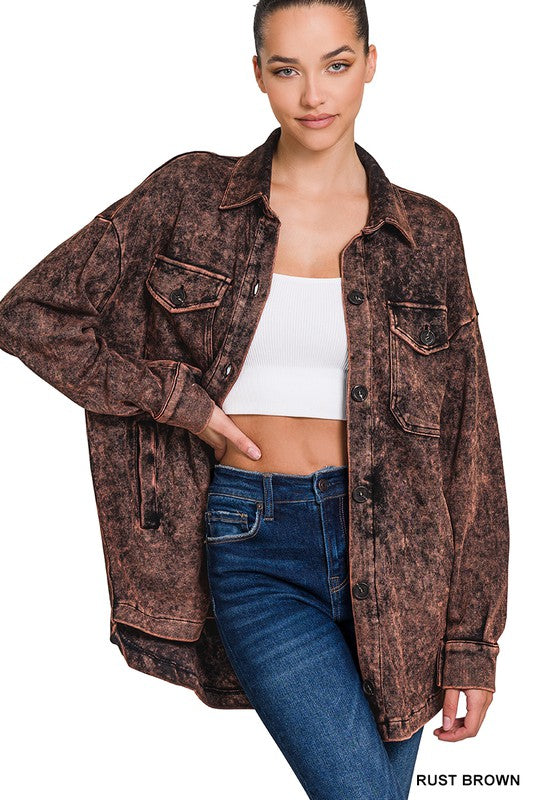 Person wearing a Mineral Washed Shacket in rust brown, oversized over a white crop top and blue jeans, effortlessly showcasing a vintage look.