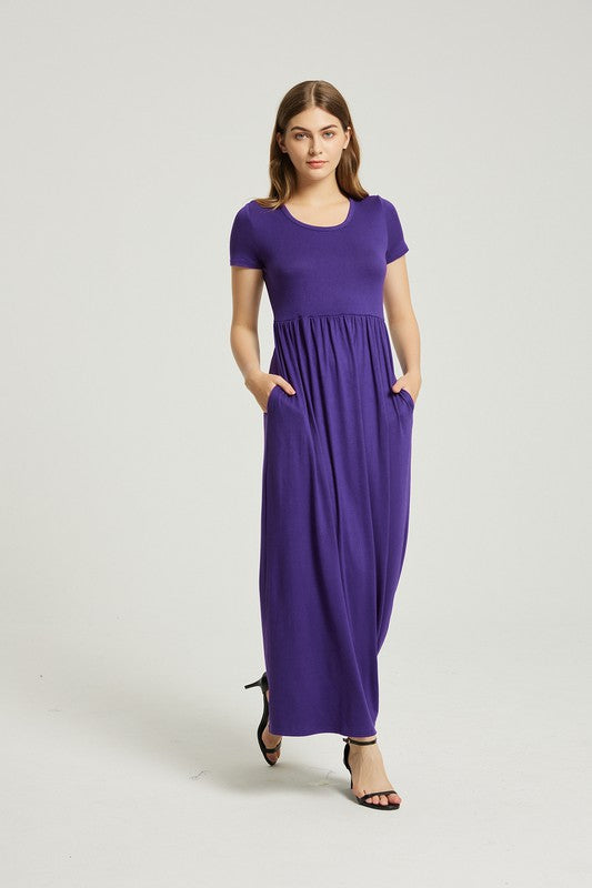 A woman elegantly poses against a plain background, wearing the vibrant Women's Summer Casual Maxi Dress With Pocket in purple, featuring short sleeves.